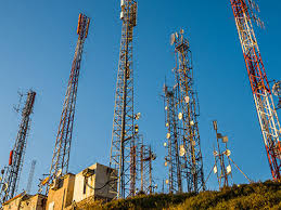 Cell towers against sky